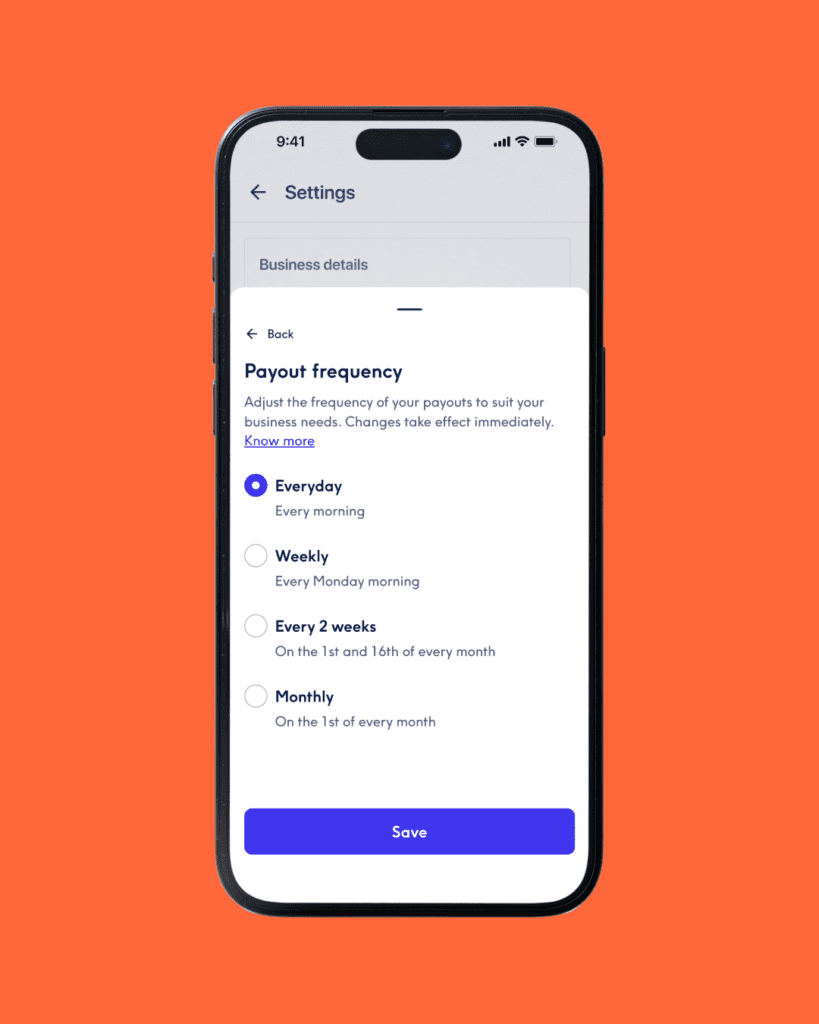 A close-up of a smartphone screen against a bright orange background, showing the "Payout frequency" settings menu. The selected option is "Everyday (Every morning)", with other unselected options for "Weekly", "Every 2 weeks", and "Monthly". A blue "Save" button is at the bottom.